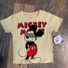 This Is A Brand New T-Shirt With Tag. Made Of 60% Cotton And 40% Polyester. Short Sleeves. Mickey Mouse Is On The Front With His Sunglasses On. Please Check Out My Closet For More Clothes, Shoes, Jewelry, Purses, Books And Much Much More!! Poshmark.Com/Closet/Katcars Ka673 Mickey Mouse Graphic Tee Tops, Playful Mickey Mouse Tops For Playtime, Casual Mickey Mouse Tops For Playtime, Cotton Mickey Mouse Top For Playtime, Mickey Mouse Outfit, Mickey Mouse Shirt, Mickey Mouse Shirts, Yellow T Shirt, Disney Junior