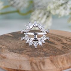 a diamond ring sitting on top of a wooden board