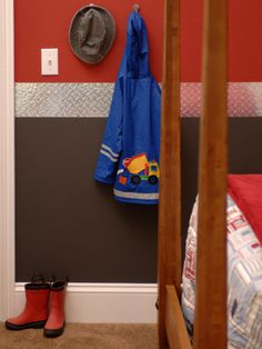 a child's room with a coat rack, hat and rain boots on the floor