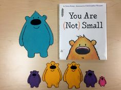 there is a book about you are not small on the table next to some cut outs