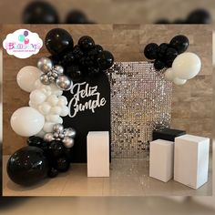 black and white balloons are on display at a party