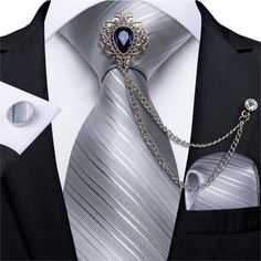 Luxury Tie with Brooch Chain, a combination of the sophistication of a necktie with the elegance of a brooch chain. This duo creates a unique and eye-catching look, adding a touch of a luxurious masculininity and personal style to formal or dressy outfits.Ties Type: Neck Tie SetTie Size: One size 59.06''(150cm) length and 3.4''(8.5cm) widthStyle: FashionSize: One SizeMaterial: SilkColor: Gray Striped*NoteDelivery Time: Due to the current global crisis (COVID-19), shipping time may be delayed. Men Tie, Luxury Ties, Crystal Brooch, College Sports, Dressy Outfits, Blue Crystals, Ties Mens, Grey Stripes, Necktie