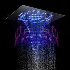 a shower head with blue and purple lights on it