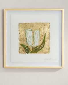 a painting hanging on the wall next to a white frame with a green plant in it