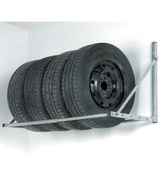 a car tire mounted to a wall with four tires on it's back end