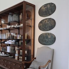 a chair sitting in front of a book shelf