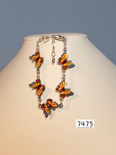 Butterfly charms have great details.  Three colors are combined to make this a lovely bracelet.  Charms are yellow with blue and red and joined with gold plated rings and chain,  Closure is a lobster claw. Bracelet measures approx. 6" to 7.5" Multicolor Dangle Jewelry With Lobster Clasp, Nickel-free Multicolor Charm Bracelet For Jewelry Making, Multicolor Charm Jewelry For Collectors, Collectible Multicolor Charms Jewelry, Multicolor Enamel Jewelry With Lobster Clasp, Nickel-free Multicolor Metal Charm Bracelet, Hypoallergenic Multicolor Metal Bracelets, Handmade Yellow Charm Bracelet Gift, Multicolor Hypoallergenic Charm Bracelet