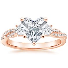 a heart shaped diamond engagement ring with two side stones