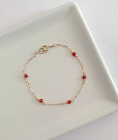 This dainty carnelian bracelet is handmade with genuine carnelian, and 14k gold filled and sterling silver metals. - Each bead measures 3mm. - Waterproof - Will not tarnish - Size up and wear as an anklet All of our jewelry is handmade with love in Nova Scotia, Canada. METALS Our jewelry is made using 925 sterling silver or 14k gold filled metals. Gold filled metals are made with a thick layer of gold to a brass core. Is is of higher quality than plated jewelry, and is a great alternative to pur Dainty Red Jewelry, Red Gold Bracelet, Gold Handmade Jewelry, Red Gemstone Dainty Bracelets, Red Carnelian Bracelets As A Gift, Red Carnelian Bracelets As Gift, Red Carnelian Bracelets For Gifts, Red Gemstone Dainty Bracelet, Red Carnelian Gemstone Bracelets