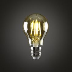 an illuminated light bulb on a black background