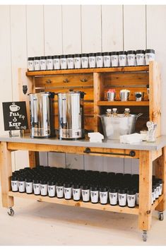 a wooden shelf filled with lots of pots and pans next to a sign on the wall