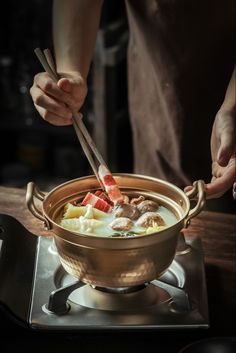 a person is stirring food in a pot