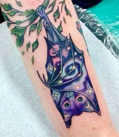 a bat with leaves on its head is shown in this tattoo art work by artist mark