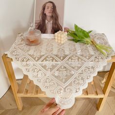 a woman is sitting at a table with flowers on it