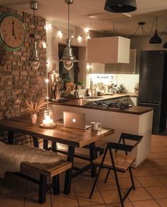 a kitchen with a table, chairs and a clock on the wall above it's counter