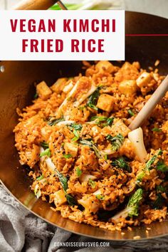 vegan kimchi fried rice in a skillet with a wooden spoon on the side