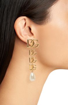 Bring Dolce&Gabbana's signature glamour to any look with these clip-on earrings flaunting goldtone logos and lustrous baroque imitation pearls. Clip-on style Nickel-free Hypoallergenic Goldtone plate/acrylic imitation pearl Made in Italy Designer Gold Metal Clip-on Earrings, Luxury Gold Clip-on Earrings With Logo, Designer Gold-tone Logo Plaque Earrings For Formal Occasions, Luxury Gold-tone Earrings With Logo Plaque, Designer Gold-tone Earrings For Formal Occasions, Designer Gold-tone Clip-on Earrings, Designer Gold-tone Metal Earrings, Designer Metal Clip-on Earrings For Formal Occasions, Designer Gold-tone Evening Jewelry