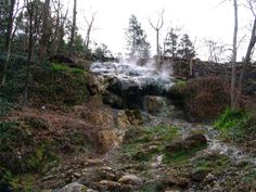 a small waterfall with steam coming out of it