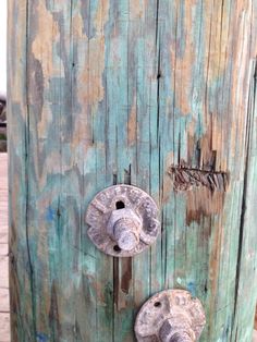 an old wooden pole with two knobs on it's sides and the door handle is missing