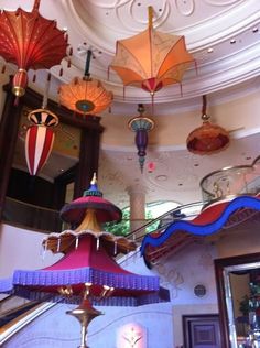 many colorful umbrellas hanging from the ceiling