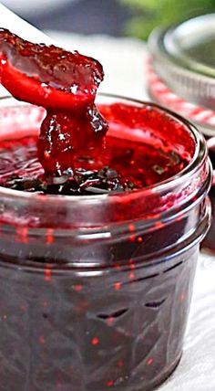 a jar filled with jam sitting on top of a table