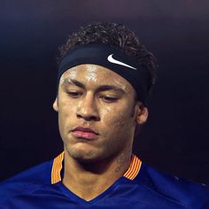 a close up of a person wearing a headband and looking at the camera with eyes closed