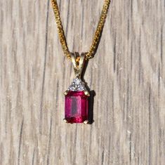 Ladies Yellow Gold Pendant set with Laboratory Grown Ruby and Diamonds. Crafted in yellow gold, this 3/4 inch pendant features an emerald cut laboratory grown ruby set with three accent diamonds. Purchase a yellow gold chain from our shop to make this the perfect everyday necklace. Each piece has been hand selected and meticulously identified and graded by a Graduate Gemologist who has been awarded a degree by the Gemological Institute of America (GIA). Please visit our Shop's About Page or our Yellow Gold Ruby Oval Pendant Jewelry, Red Pendant Jewelry With Brilliant Cut, Ruby Birthstone Pendant In Yellow Gold, Elegant Pendant Jewelry With Lab-created Ruby, Ruby Pendant With Diamond Cut, Gold Pendant Set, Ruby Set, Filigree Engagement Ring, Sterling Silver Bangle Bracelets