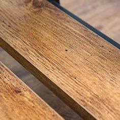 a wooden bench sitting on top of a hard wood floor