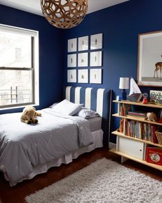 a bedroom with blue walls and white bedding