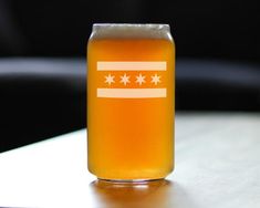 a glass filled with beer sitting on top of a table