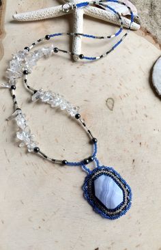 Blue lace necklace agate beaded necklace stone pendant necklace quartz crystal necklace boho blue necklace gift unique jewelry women SLD. Handmade jewelry. Blue lace agate brick stitch beaded pendant. Blue lace agate is a calming stone that's said to bring tranquility. It's a stone used in meditation and sometimes called the stone of serenity. it activates the throat in chakra. I kept this pretty simple as the pendant is the star. 4mm hematite stone beads, 6mm quartz crystal beads, 13 0 seed bea Beaded Agate Pendant Crystal Necklaces, Brown Gemstone, Boho Blue, Necklace Stone, Lace Necklace, Hematite Stone, Quartz Crystal Necklace, Stone Pendant Necklace, Blue Lace Agate