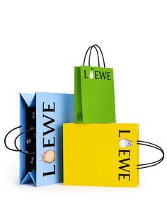 three shopping bags sitting on top of each other with the words llewe printed on them