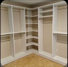 an empty walk in closet with white shelves