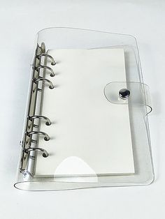 a clear binder with two rings on it