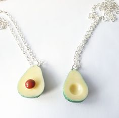 an avocado necklace with a cherry on it