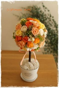 an arrangement of flowers in a white vase