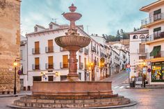 a fountain in the middle of a city street