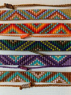 beaded bracelets are lined up on a table