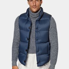 A lightweight layer that adds warmth and
  depth, this puffy mid-blue down vest is a versatile
  transitional piece that lends any look some
  dynamic volume. Blue Duck Down Puffer Outerwear, Winter Down Sleeveless Vest, Winter Sleeveless Down Vest, Navy Down Puffer Outerwear, Blue Down Puffer Jacket, Blue Nylon Outerwear With Padded Collar, Sleeveless Blue Outdoor Outerwear, Sleeveless Blue Outerwear For Outdoor, Casual Blue Vest For Winter