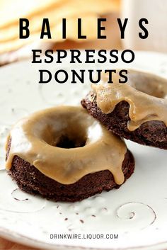 two chocolate donuts on a white plate with the words bailey's espresso donuts