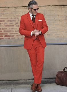 Formality and fun can coexist! Introducing our Naples Fiery Orange Tweed Suit - a perfect way to add a touch of vibrancy and showcase your bold personality. Crafted from pure wool fabric, this suit will keep you warm while making you look effortlessly sharp and stylish. The solid fiery orange color embodies the passion of red and the positivity of yellow. Whether you're the groom, a groomsman, or a guest, nothing less than perfection will do for your big day. So don't hesitate to go against the Fitted Orange Suits For Fall, Tailored Red Wool Suits, Red Wool Suits For Work, Red Wool Suit For Workwear, Red Wool Suits For Workwear, Red Fitted Wool Suit, Fitted Red Wool Suit, Red Wool Suits For Winter, Red Fitted Tweed Blazer