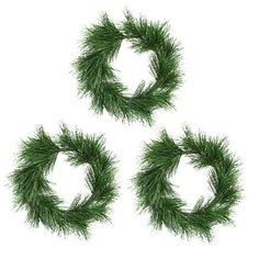 three pine wreaths on a white background