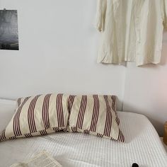 a bed that has some pillows on top of it and a lamp next to it