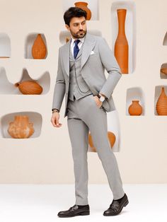 This grey 3-piece slim-fit suit is the epitome of sophistication and style. The jacket features wide lapels, creating a bold statement and showcasing a keen eye for detail. The vest, with its matching lapels, further elevates the aesthetic and provides a cohesive look. Upgrade your wardrobe with this standout piece and make a lasting impression at your next event. Color: grey Material: 60% wool, 30% polyester, 7 viscose, 3% elastane Suit includes blazer, waistcoat, & trousers Single-breasted sui Tailored Gray Three-piece Suit With Suit Collar, Fitted Gray Tuxedo Blazer, Gray Fitted Three-piece Suit For Office, Fitted Gray Three-piece Suit For Office, Tailored Gray Three-piece Suit For Business, Gray Tailored Three-piece Suit For Office, Gray Tailored Three-piece Suit For Semi-formal Occasions, Tailored Gray Three-piece Business Suit, Fitted Gray Double Breasted Suit For Office