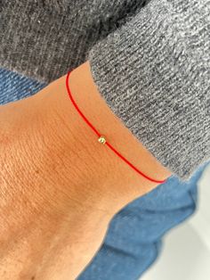 This red string bracelet is made from waterproof silk string and solid 14K gold, sterling silver, or  24K gold vermeil  3 mm bead. Wish bracelet is a beautiful way to give someone you care for a wish. All they have to do is make a wish and then tie the cord around their wrist. When the cord finally wears down and breaks the wish is released and will come true - so they say! Details:  * 14K solid gold, sterling silver or 24K gold vermeil bead - 3 mm; * Waterproof Silk String * Adjustable clasp st Minimalist 14k Gold Red Bracelets, Minimalist Red 14k Gold Bracelets, Minimalist Red 14k Gold Bracelet, How To Make Red, Red String Bracelet, Red String, Red Bracelets, Gold Work, Wish Bracelets