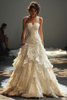 a woman is walking down the runway wearing a wedding dress with ruffles on it