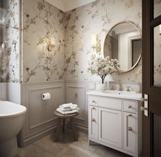 a white bathroom with floral wallpaper and marble counter tops, along with a round mirror above the sink