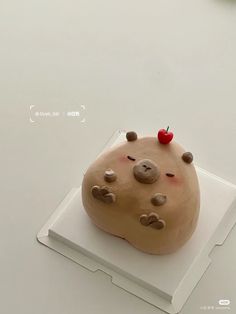 a cake shaped like a rock on top of a white plate with a cherries on it