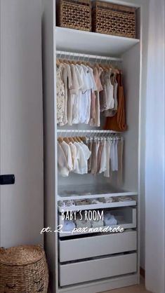 an organized closet with clothes and baskets on the bottom shelf, next to a wicker basket