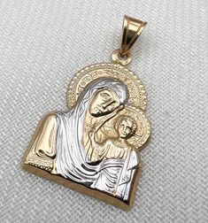 Religione offers a large selection of fine religious jewelry. Every piece of our collection is designed and crafted by talented craftsmen located in the Holy Land using pure gold and genuine diamonds. Religione designs are meant to emphasize the eternal shine that faith in God brings us.  Specification: Gold: 14k solid gold 2.00g Pendant Size: length 1.00inch width 0.8inch Each of our Jewelry pieces: Includes jewelry certificate.  Comes in an elegant jewelry box.  Shipped globally by top carrier Engraved Yellow Gold Crucifix Jewelry, Stamped 14k Gold Spiritual Jewelry And Charms, Gold Spiritual Jewelry And Charms For Wedding, Spiritual Yellow Gold Wedding Jewelry And Charms, Engraved White Gold Spiritual Jewelry And Charms, White Gold Crucifix For Anniversary, Hallmarked Yellow Gold Crucifix Jewelry, Gold Spiritual Jewelry With Diamond Cut, White Gold Polished Spiritual Jewelry And Charms